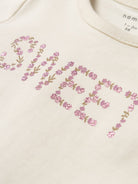 Glitter chest print detail on Osia top