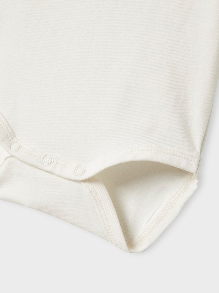 Close-up of a white bodysuit on a light gray background
