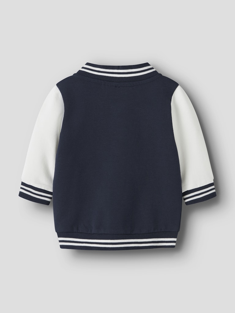 Navy blue varsity jacket with white sleeves on a light gray background