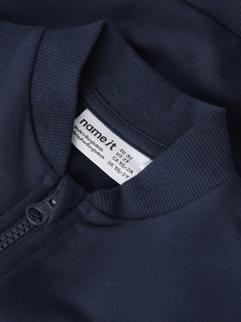Navy blue garment with a 'name it' label on the collar