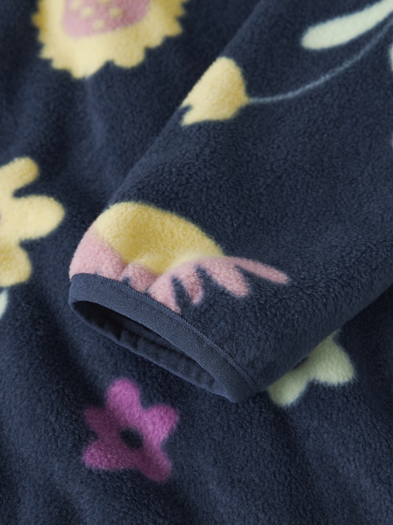 Navy fleece blanket with colorful floral patterns