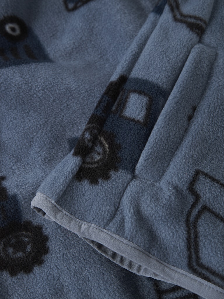 Close-up of a blue fabric with black geometric patterns