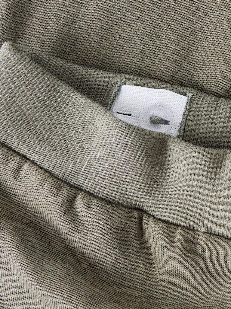 Close-up of a green fabric with a brand label on it