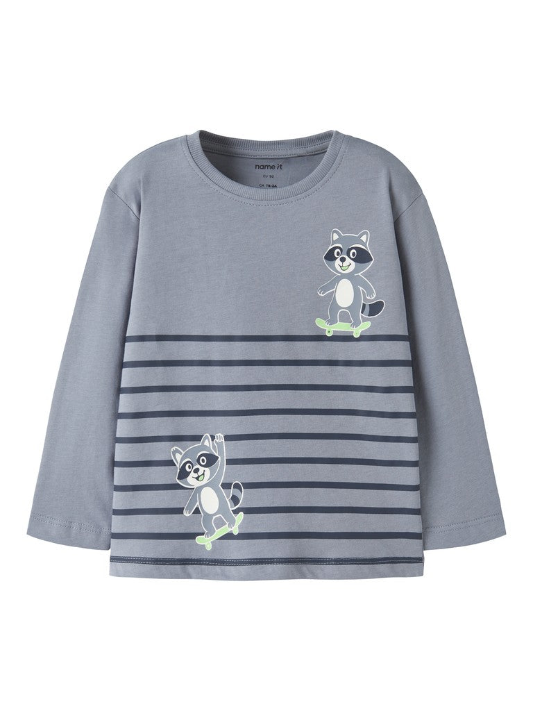 A children's long-sleeve t-shirt in a dusty slate blue-gray color, featuring horizontal dark gray stripes across the lower half and two cartoon raccoon graphics on the chest.