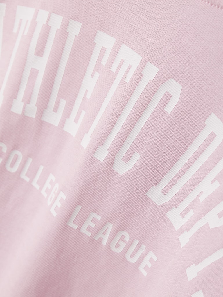 Pink tee with white text on a pink background