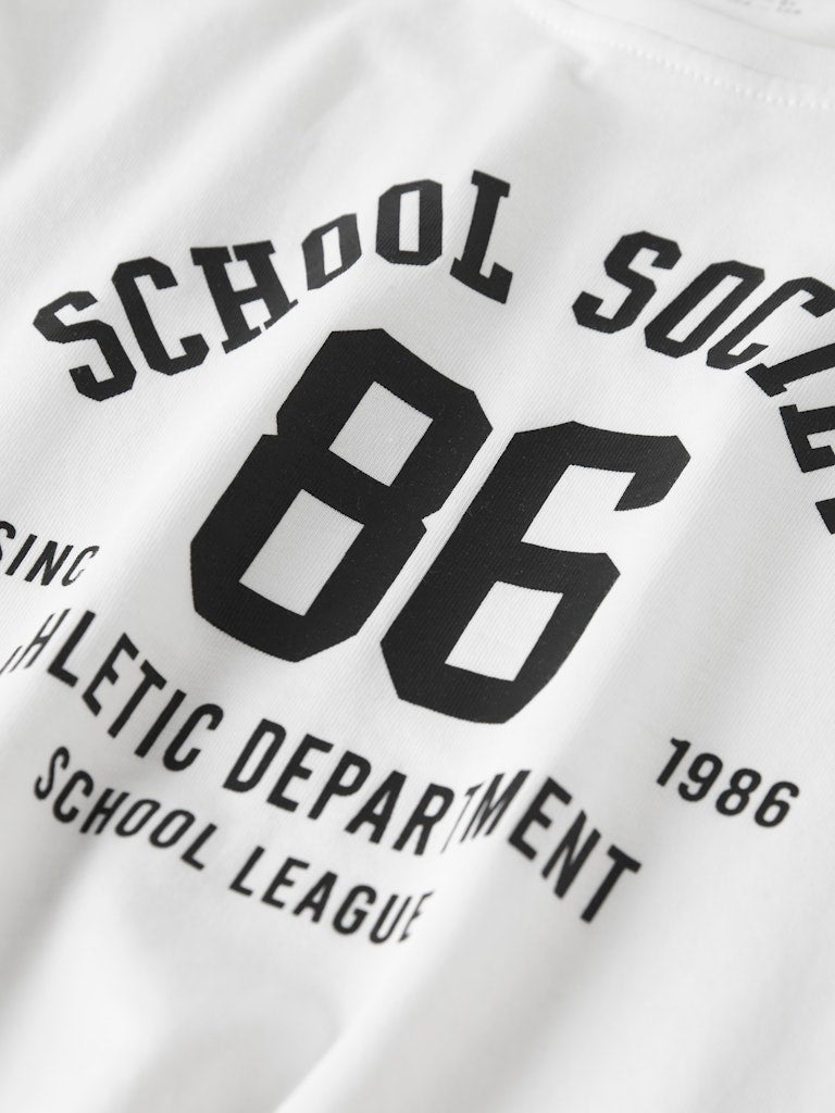 White tee with black text and numbers printed on it
