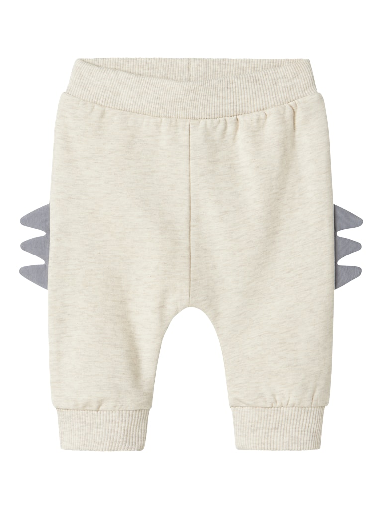 Beige baby pants with gray dinosaur spikes on a white background