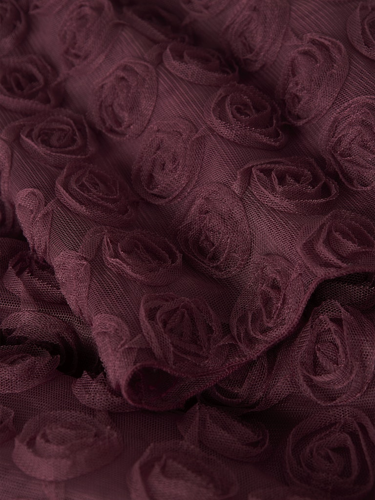 Close-up of dark purple fabric with rose pattern