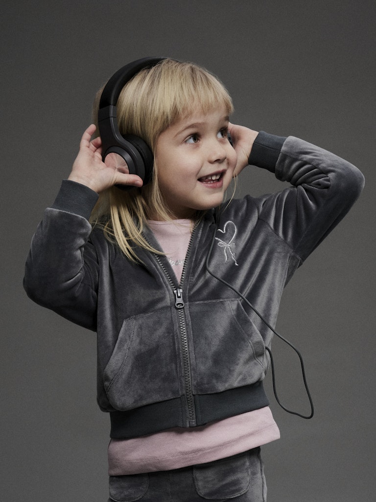 Child wearing large headphones on a dark background