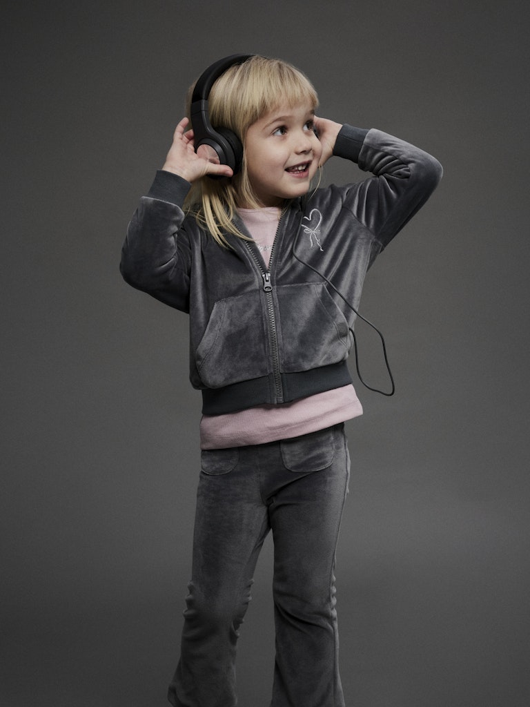 Child wearing headphones on a gray background