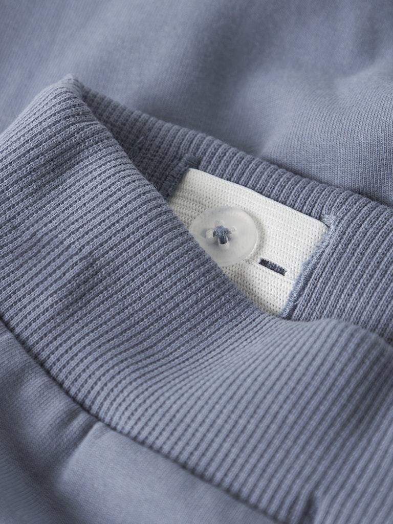Close-up of a blue garment with a brand label.