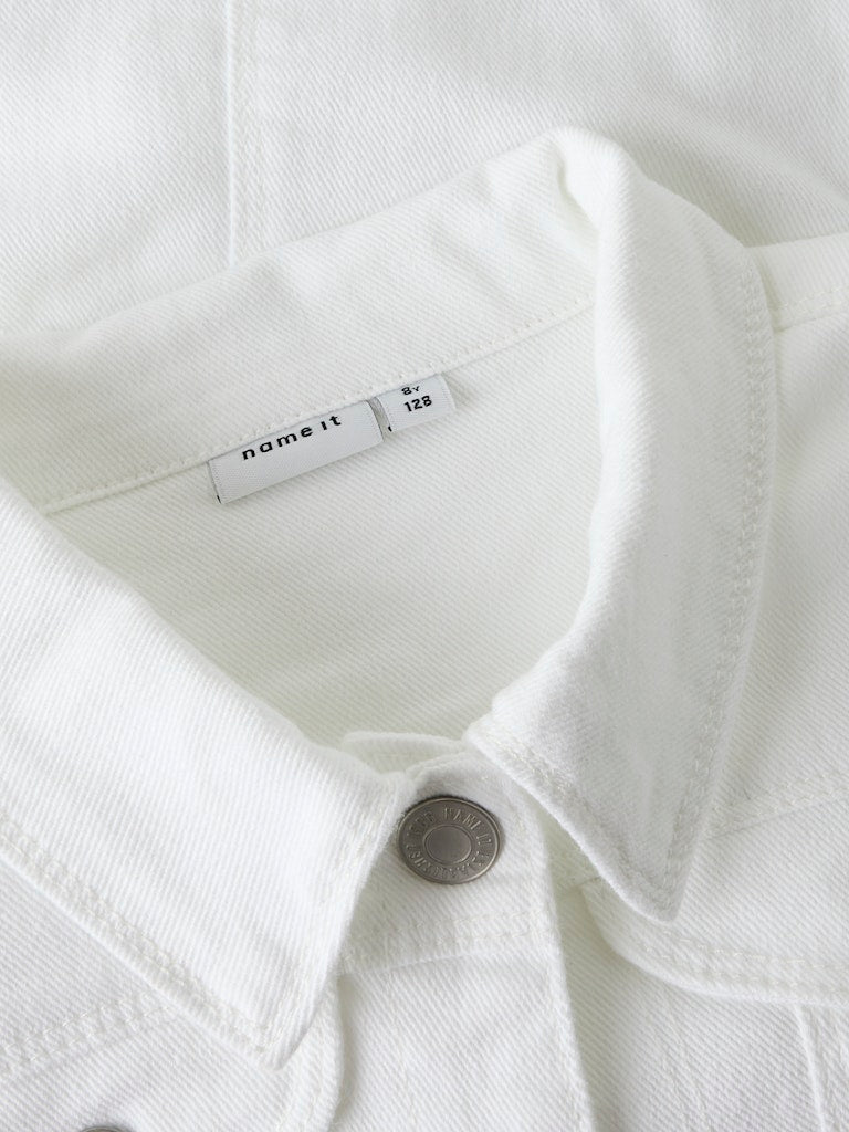Close-up of a white garment with a brand label on a white background