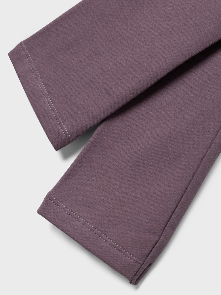Close-up of a pair of purple pants on a light gray background