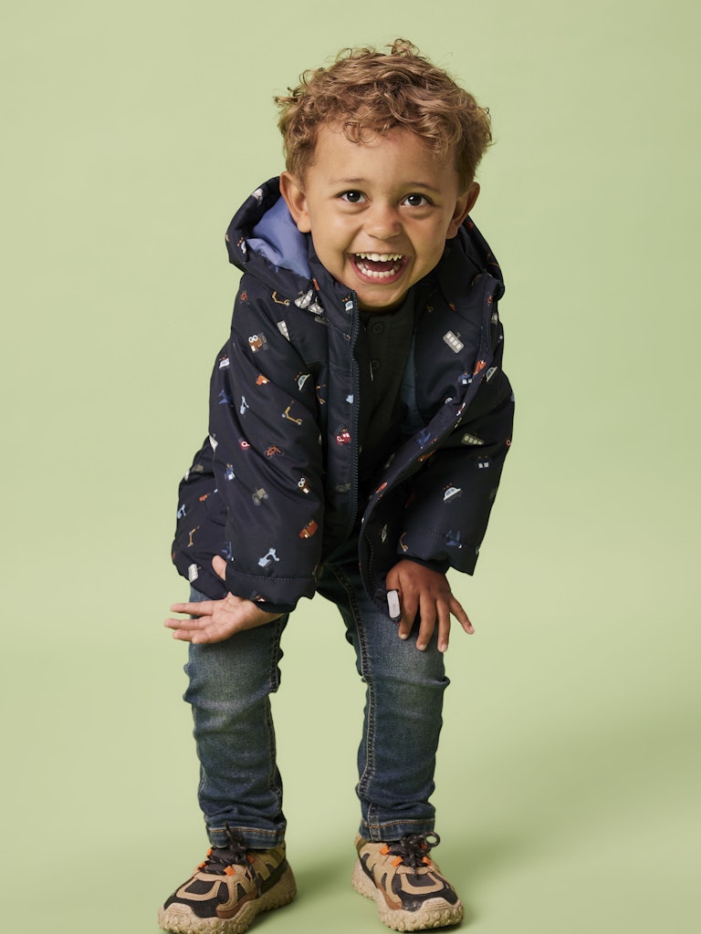 Boy wearing max padded all over truck print jacket in Dark Sapphire
