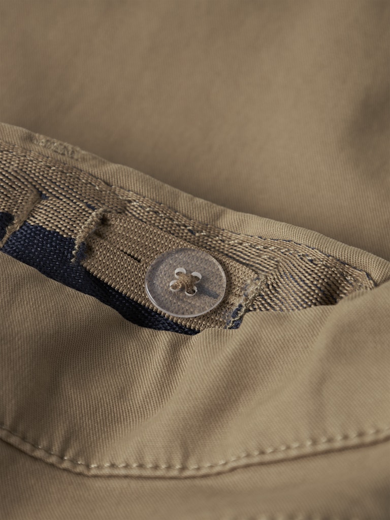 Close-up of a button on a beige fabric background