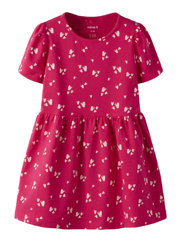 Pink dress with white bow pattern on a white background