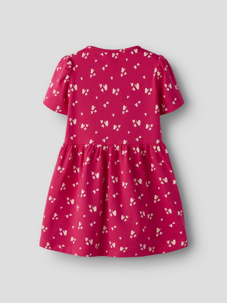 Pink dress with white floral pattern on a light gray background