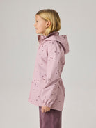 Child wearing a pink raincoat with heart patterns on a light gray background