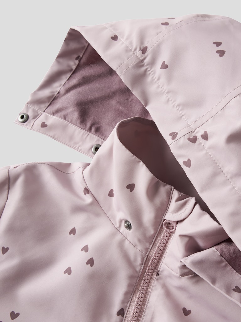 Pink jacket with heart patterns on a light gray background