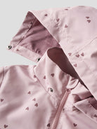 Pink jacket with heart patterns on a light gray background