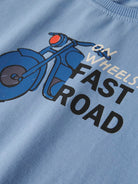 Light blue sweatshirt with a graphic of a motorcycle and text 'On Wheels Fast Road' on a plain background.
