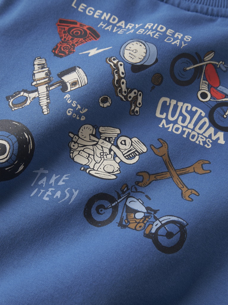 Blue shirt with motorcycle-themed graphics and text on a blue background