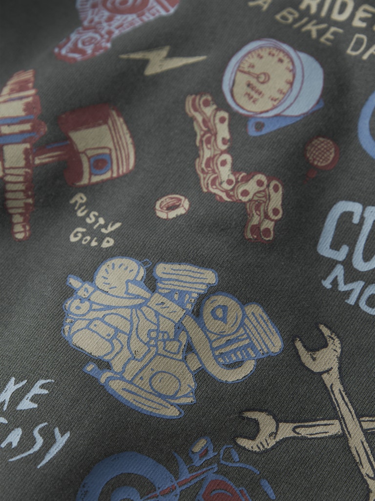 Textile with motorcycle-themed graphics and text on a dark background