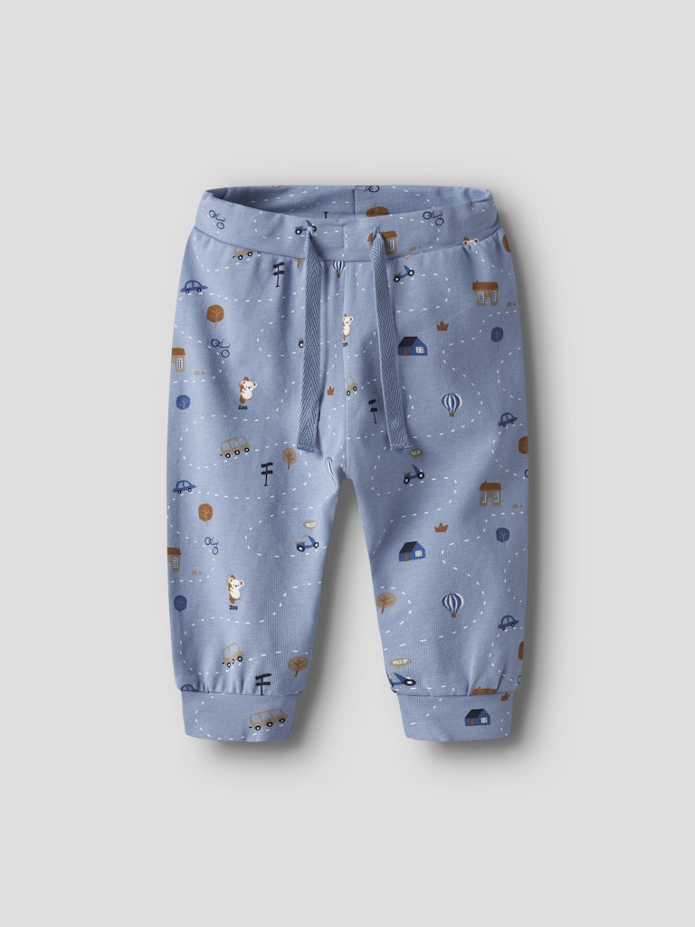 Blue children's pants with vehicle print on a light gray background