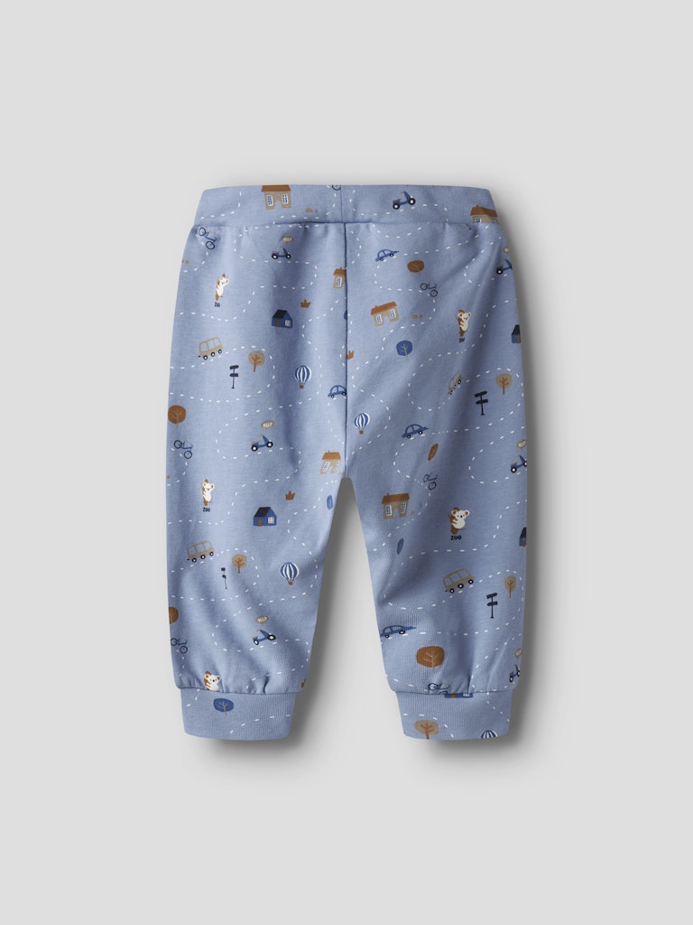 Blue children's pants with vehicle pattern on a light gray background