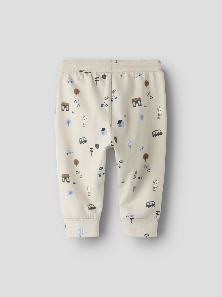 Beige baby pants with small prints on a light gray background