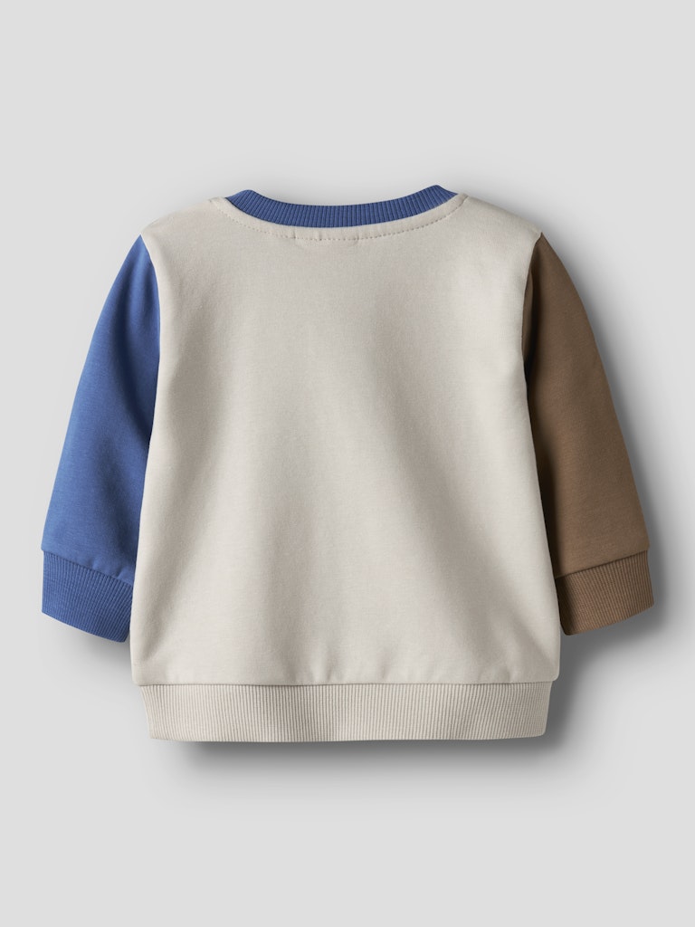 Color-blocked sweater with blue and brown sleeves on a light gray background