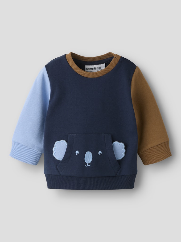 Children's sweater with bear design on a light gray background
