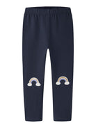 Navy blue pants with rainbow designs on a white background