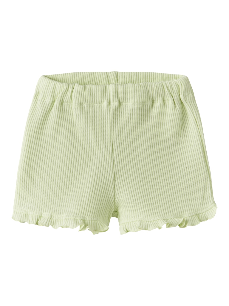 Light green shorts with ruffled hem on a white background