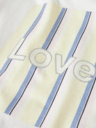 Textile with 'love' embroidery on a striped background
