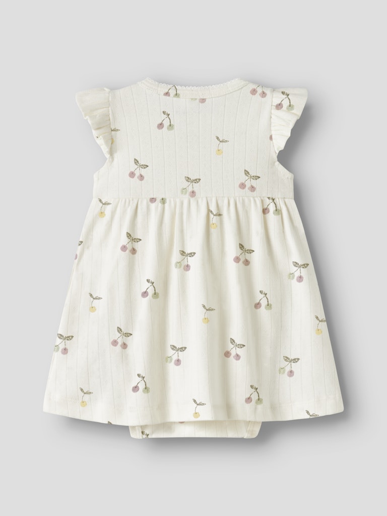 Cream dress with cherry print on a light gray background