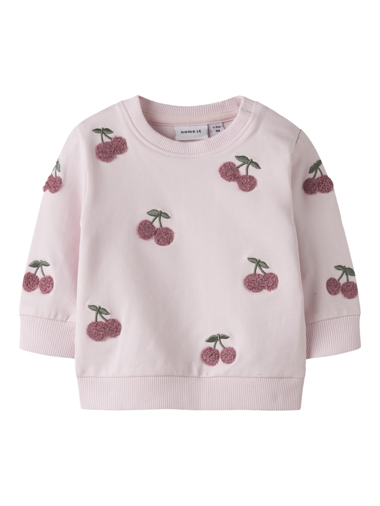 Pink sweater with cherry patterns on a white background