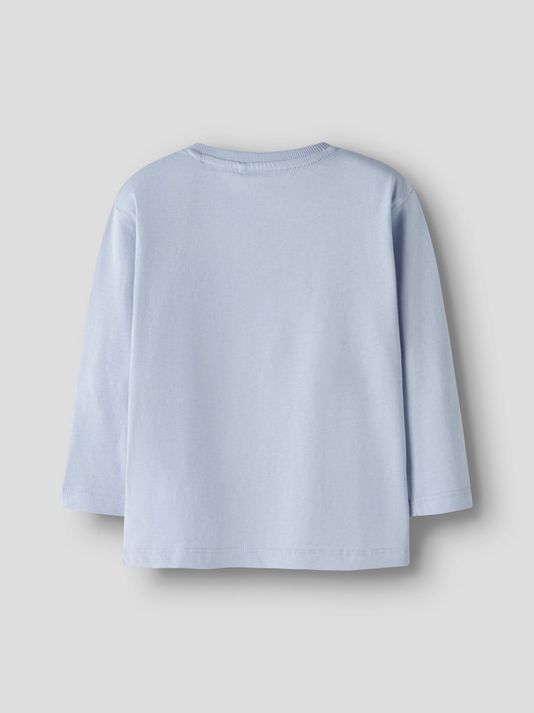 Light blue shirt on a gray background