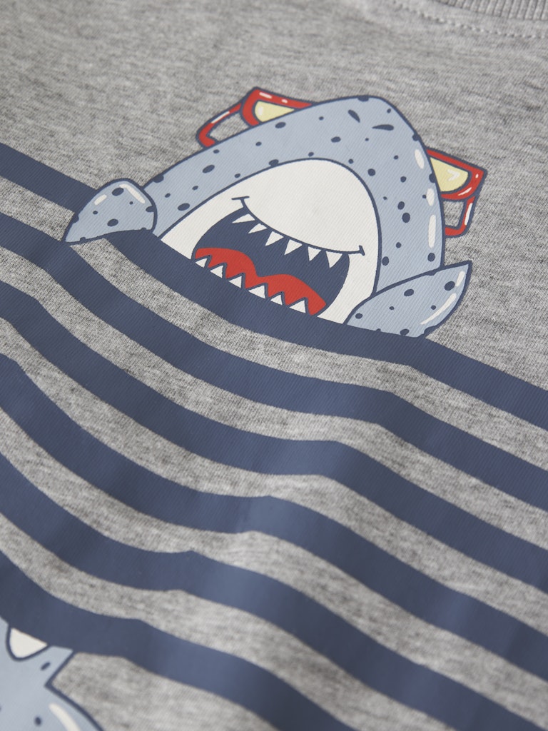 Shirt with a shark design on a gray and blue striped background