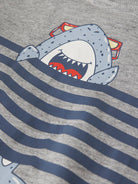 Shirt with a shark design on a gray and blue striped background