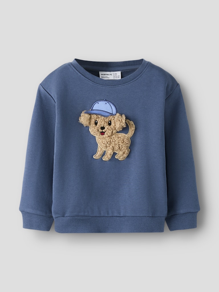 Blue sweatshirt with a dog graphic on a gray background