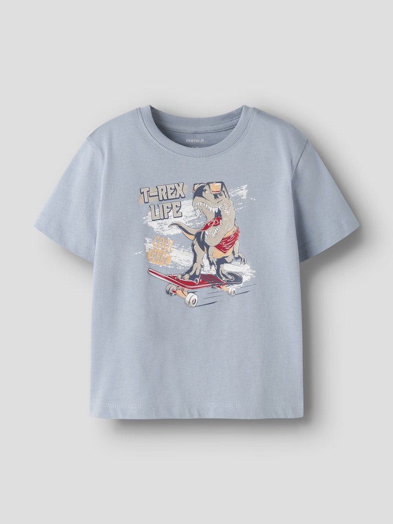 Light blue t-shirt with a dinosaur graphic on a light gray background