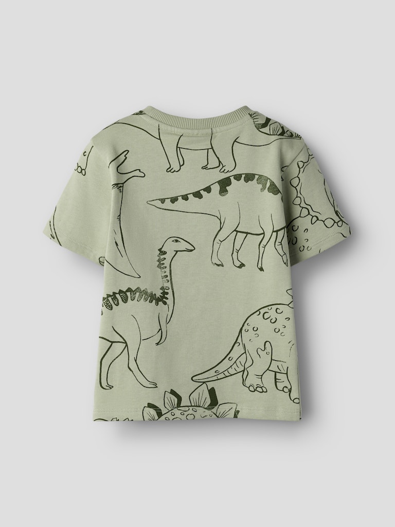 Green t-shirt with dinosaur pattern on a white background