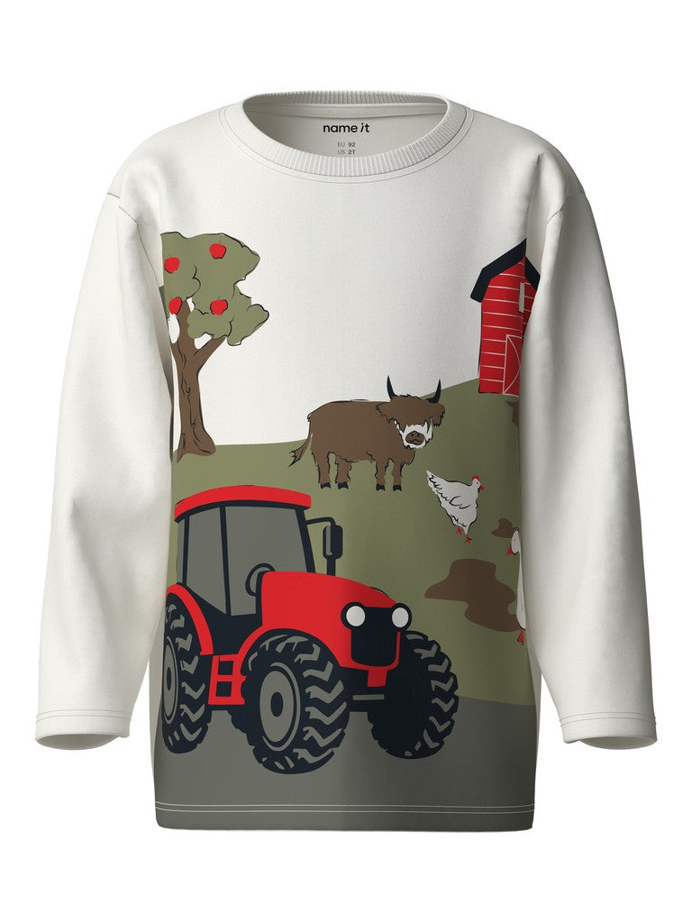 A white long-sleeve crewneck sweatshirt featuring a colorful graphic print of a farm scene with a red tractor, barn, cow, chicken, and tree. The brand name 'name it' is printed inside the collar.