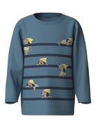A kids' long-sleeve crewneck sweatshirt in slate blue, featuring a horizontal striped pattern with cartoon dachshund dogs peeking out from behind the stripes. The brand name 'name it' is visible on the inner neck label.