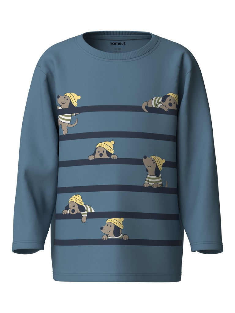 A kids' long-sleeve crewneck sweatshirt in slate blue, featuring a horizontal striped pattern with cartoon dachshund dogs peeking out from behind the stripes. The brand name 'name it' is visible on the inner neck label.