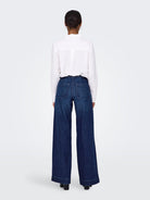 Model back view of high waisted button fly jeans