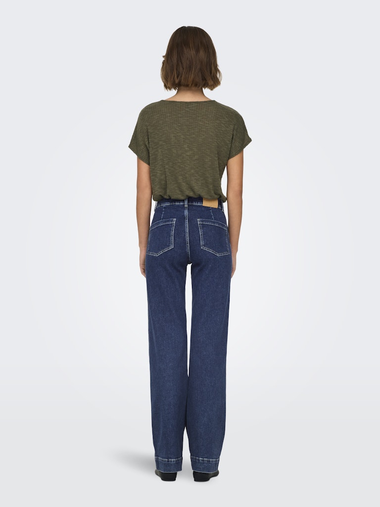 Person wearing a green t-shirt and blue jeans on a white background