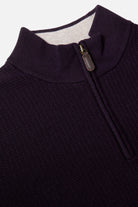 Close-up of a Benetti Oliver Plum 1/4 Zip knit showing the ribbed collar and quarter-zip with leather pull tab.