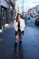 Close-up of the white faux fur jacket texture